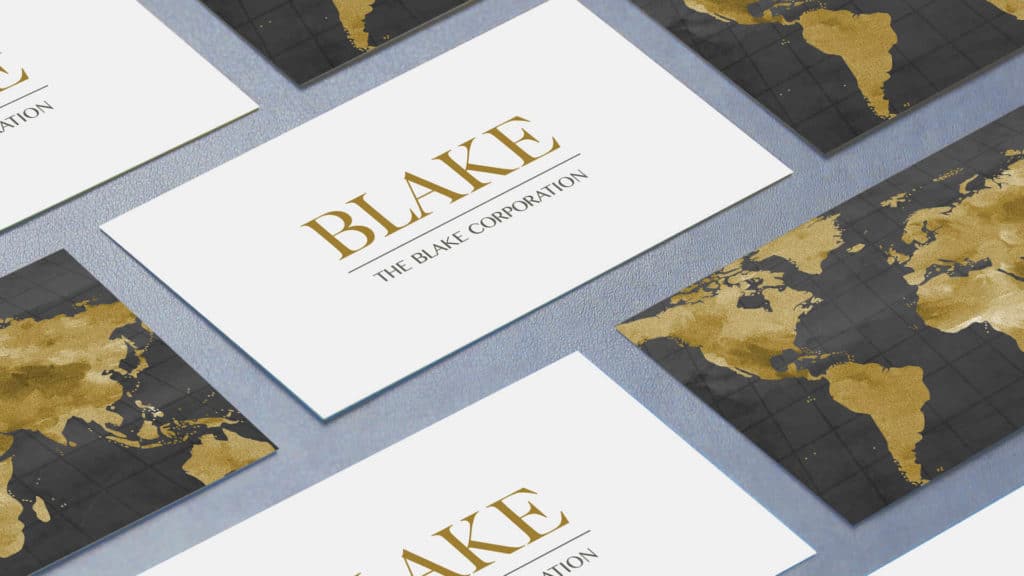 white business cards with The Blake Corporation logo and black cards with golden global map on back