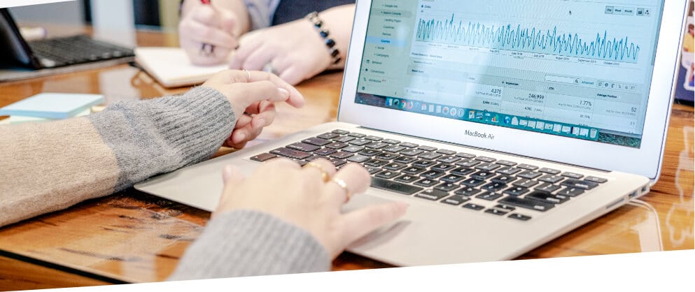 woman at computer looking at SEO reports